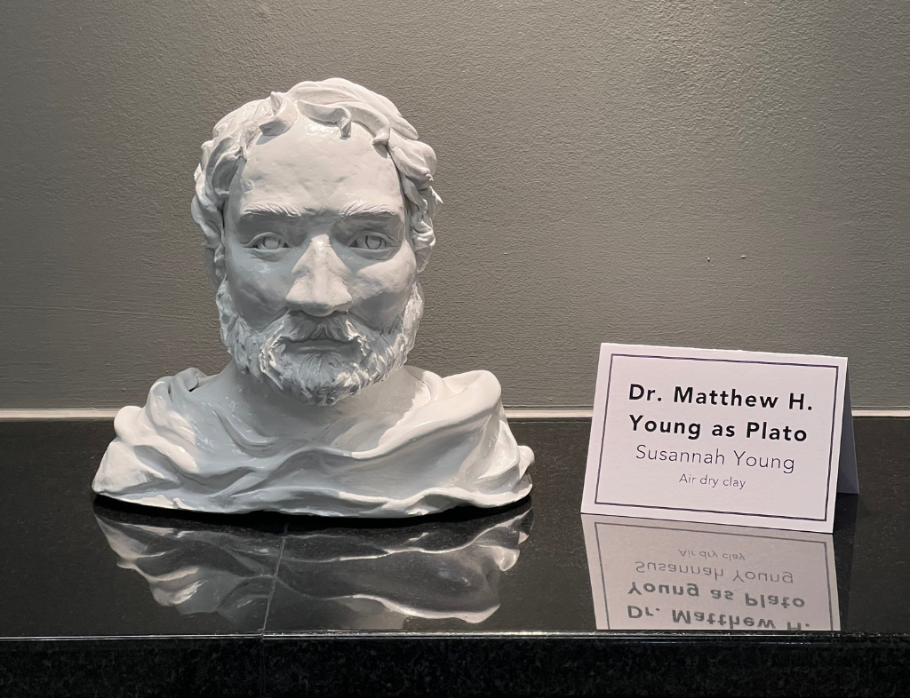 Dr. Matthew H. Young as Plato depicts a draped plaster bust by artist Susannah Young
